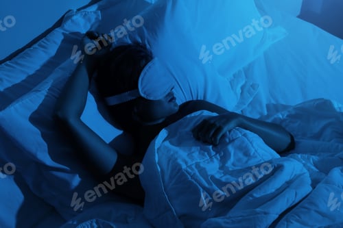 Preview: Woman sleeping with a sleep mask on her eyes