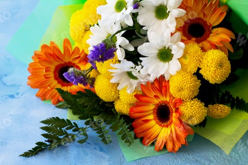 Preview: Basket bouquet of gerbera and chrysanthemums on a stone background.