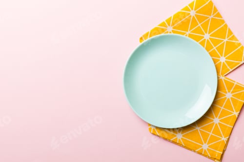 Preview: Top view on colored background empty round blue plate on tablecloth for food