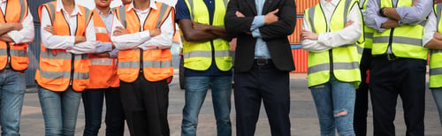 Preview: Factory construction site or container warehouse people standing with arms crossed
