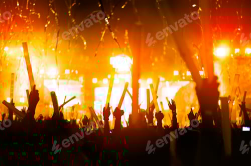 Preview: Enthusiastic Crowd at Brightly Lit Concert