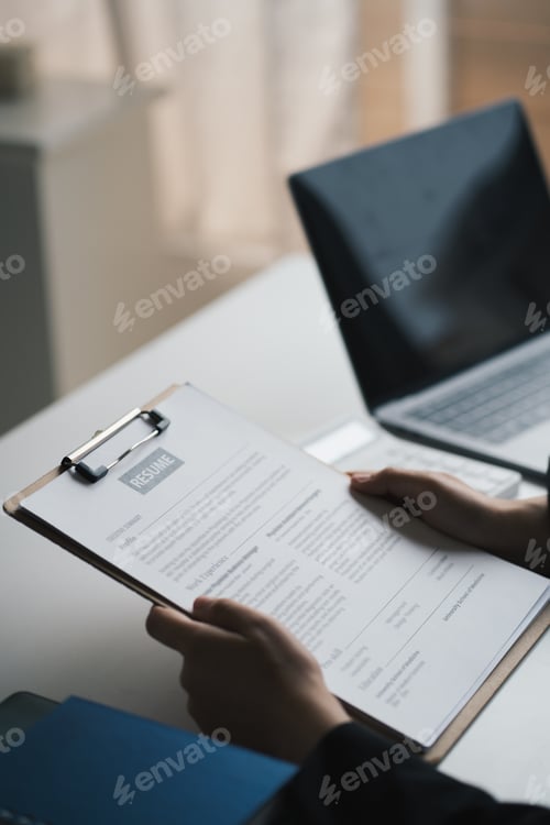Preview: Woman submits job application, Interviewer reading a resume.