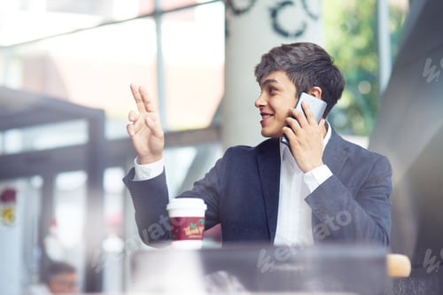 Preview: Cheerful young businessman resting in the cafe