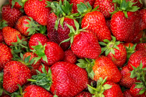 Preview: Strawberries in a basket in the garden at the farm. Selective focus.
