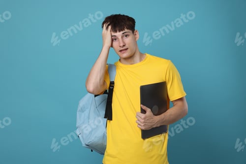 Preview: Worried student with laptop on light blue background