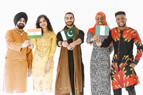 Preview: Group of diverse smiling men wearing in folk costumes