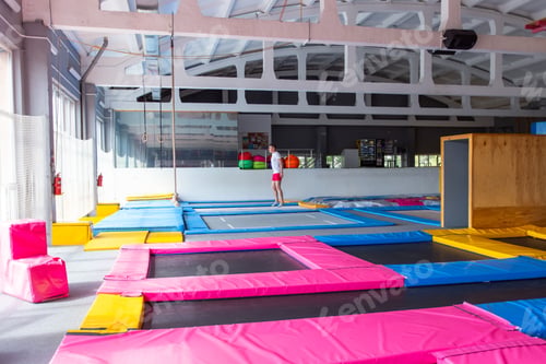 Preview: Fitness, fun, leisure and sport activity concept - Handsome happy man jumping on a trampoline