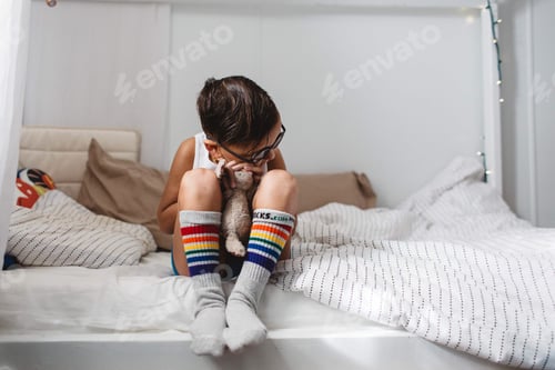 Preview: Boy Sitting on Bed Hugging Stuffed Animal