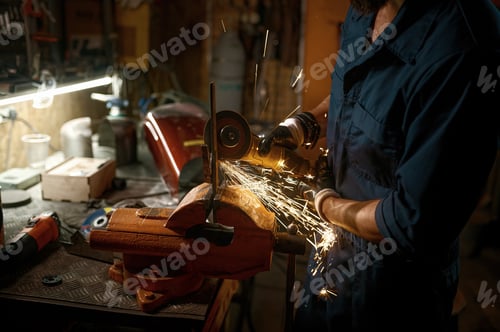 Preview: Repairman making and fitting spare part manually while working in workshop