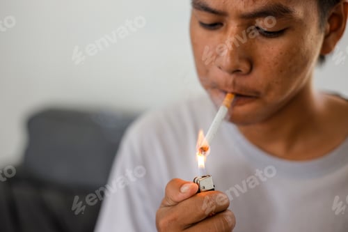 Preview: Close up of young man smoking and light up a cigarette.