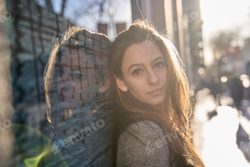 Preview: portrait of beautiful young woman outdoors with backlighting