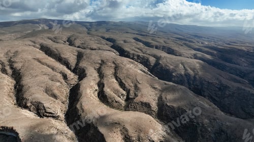 Preview: Stunning Socotra landscape featuring rugged hills and expansive sky under bright sunlight