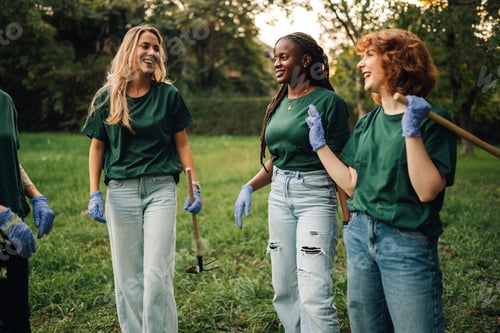 Preview: Volunteers walking and talking during cleanup in park
