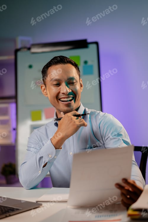 Preview: Asian man in dark office, company employee working overtime, working in the middle of the night, wor