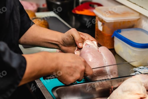 Preview: Close up Chef prepared cutting chicken breast