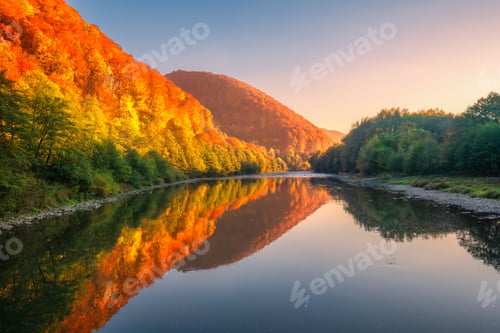Preview: Lake in mountains with red and orange trees at sunset in autumn