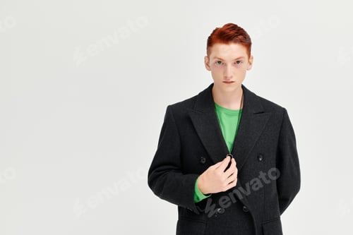 Preview: A young man with red hair shows off trendy winter fashion in a stylish studio