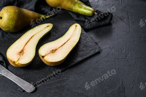 Preview: Pears and pear halves. Farm eco fruits. Black background. Top view