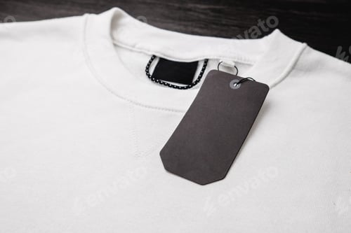 Preview: Empty black label on white sweatshirt for logo, size and price.