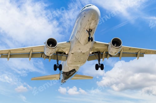 Preview: View of a plane landing at the airport under the clouds of blue sky