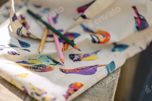 Preview: Little girl paints in open air in spring blooming fairytale park. Children's drawings.