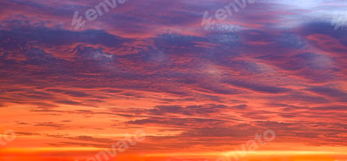 Preview: Panoramic colorful sunset sky with dramatic orange sunlight clouds on idyllic evening sky background