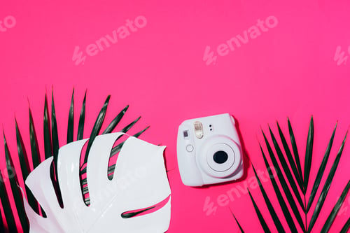 Preview: Vilnius, Lithuania - September 16, 2019: FUJIFILM INSTAX Mini Instant Film Camera on pink background