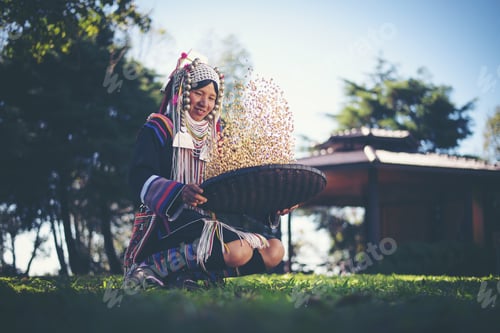 Preview: Akha in the north of Thailand enjoying coffee from shell by bamboo basket with traditional cloth.