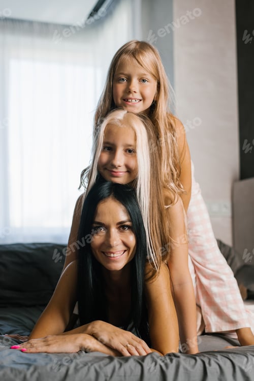 Preview: Mother and two Daughters in Home Clothes are Resting