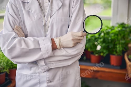 Preview: Botanist holding a magnifying glass in her hand