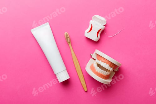 Preview: Mouthwash and other oral hygiene products on colored table top view with copy space.