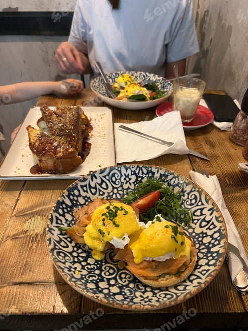 Preview: Fried eggs benedict in a plate on a served table