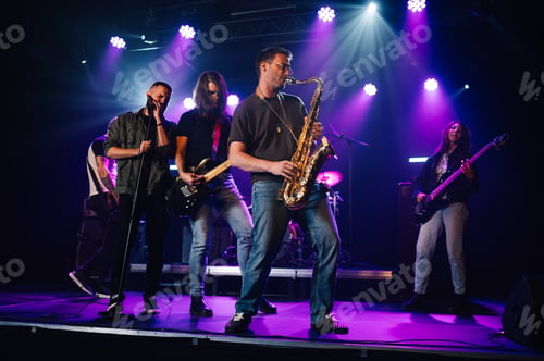 Preview: Music band playing live on stage during a concert with purple lights
