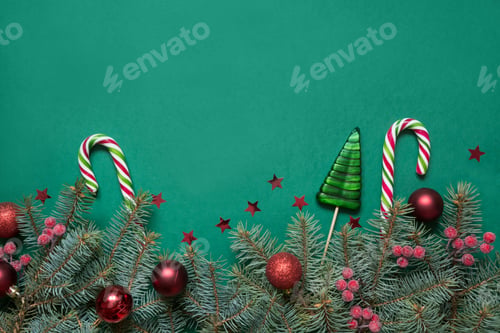 Preview: Christmas tree branches, red glass balls on green with copy space. Top view. Holiday card.