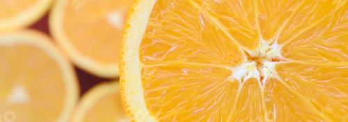 Preview: Top view of a fragment of the orange fruit slice on the background of ma