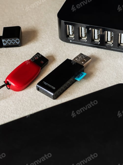 Preview: Vertical selective focus closeup of flash drives, and multiple USB ports on the desk