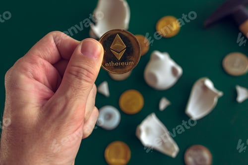Preview: Hand taking Ethereum from broken piggy coin bank