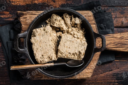 Preview: Halva with sunflower seeds and honey in pan. Wooden background. Top view
