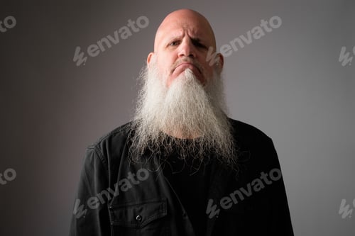Preview: Face of mature bald bearded man looking angry