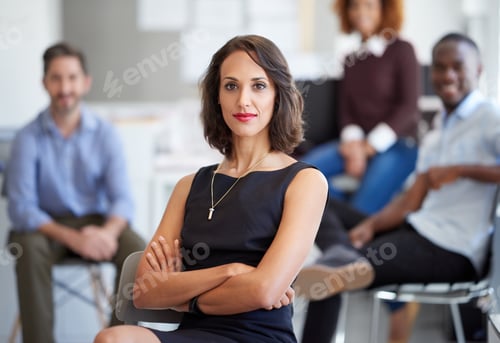 Preview: I have their support. Portrait of an attractive businesswoman with coworkers in the background.