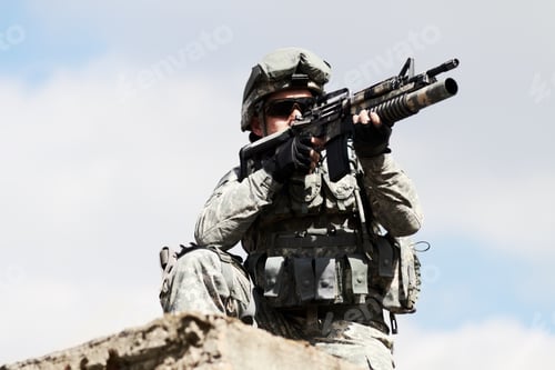 Preview: Low angel view of a sniper crouched down on a roof of a building against a sky background