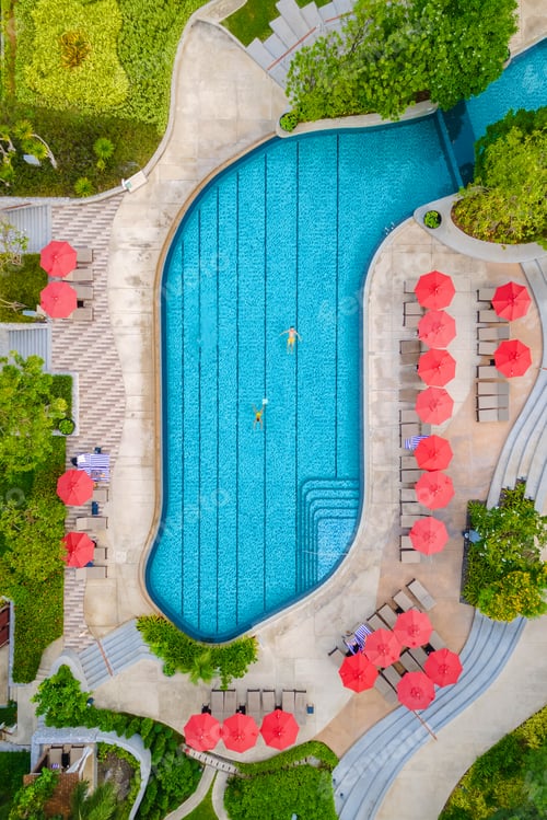 Preview: drone view from above at a couple swimming in an infinity pool on a luxury vacation in Thailand