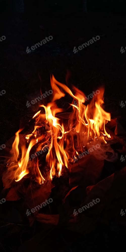 Preview: Vertical shot of a bonfire in the dark
