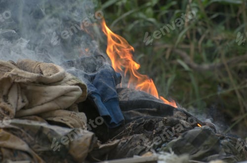 Preview: Closeup shot of burning clothes on the grass
