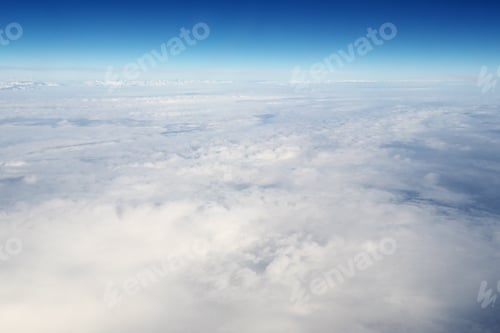 Preview: Mountain range and white clouds in blue sky at day.