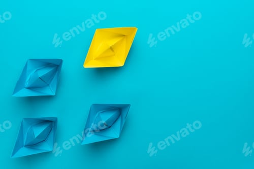 Preview: Yellow Paper Ship Ahead of Blue Ones Leadership Concept with Copy Space