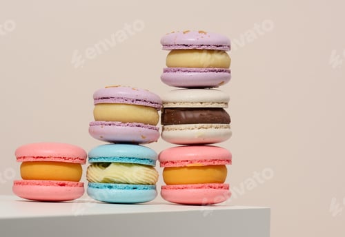 Preview: Baked round macarons on a beige background, delicious dessert, bottom view