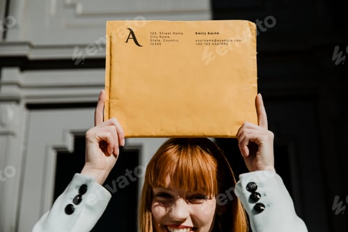 Preview: Smiling woman holding a brown package