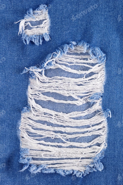 Preview: Blue jeans denim background texture. Torn jeans fabric material surface