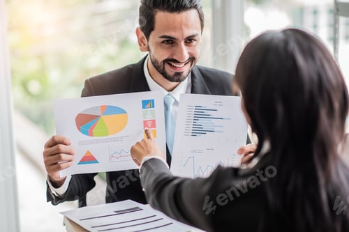 Preview: businessman talks to an African businesswoman or partner about company earnings or stock growth